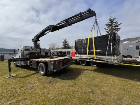 AAA Septic crane truck delivering site equipment