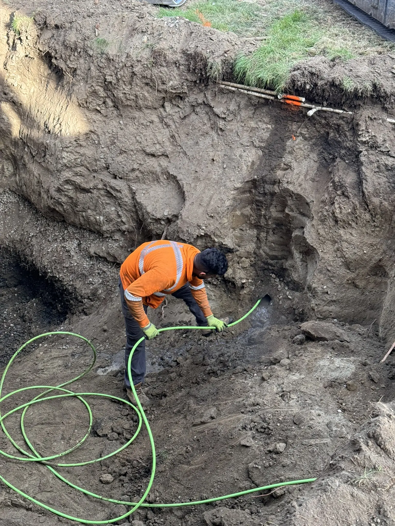 Crew member working below grade on a septic system